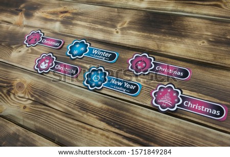 Color sticker with Christmas illustration on wooden background