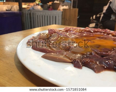 Marinated Pork in white plate, preparation recipe before cooking