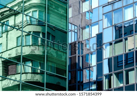 Windows, lines and reflections on this two buildings that crop the picture in two
