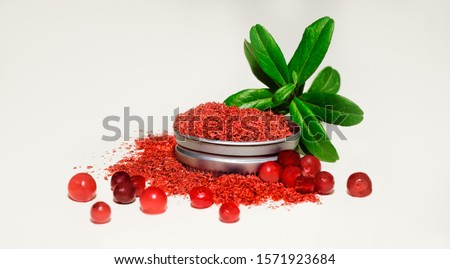 Lingonberry powder full antioxidant of dried wild Nordic berries. Red flour is high in antioxidant vitamins and fiber in a concentrated form. Add a spoon of breakfast, smoothie or use it for baking Royalty-Free Stock Photo #1571923684