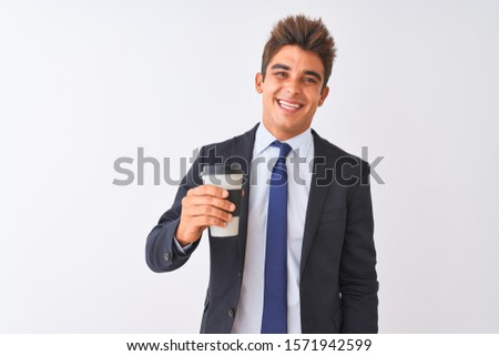 Young handsome businessman wearing suit holding coffee over isolated white background with a happy face standing and smiling with a confident smile showing teeth