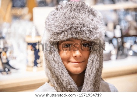 Young girl wearing iceland hat with fur.