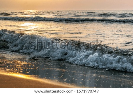 sunset on the sea, sea waves red from sunlight
