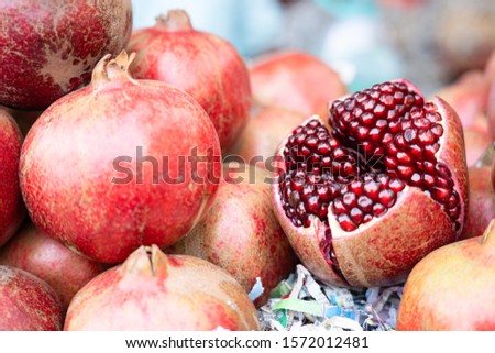 Close up of fresh pomegrante for extract to fruit water. Royalty-Free Stock Photo #1572012481