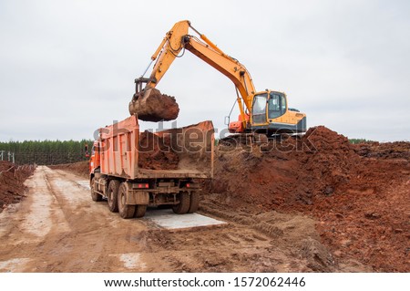  Digging and land planning at a construction site. Construction excavator at earthworks. Construction machinery at the construction site Royalty-Free Stock Photo #1572062446