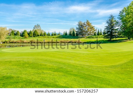 Golf course with gorgeous green and pond