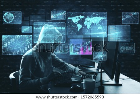 Hacker at desktop using laptop with digital business interface. Hacking and innovation concept