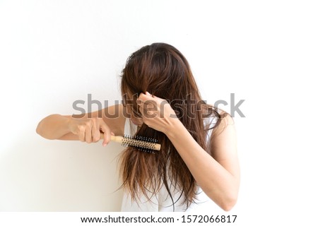 Woman brushing her wet messy hair after bath with comb, Thin hair porblem. Hair Damage, Health And Beauty Concept. Royalty-Free Stock Photo #1572066817