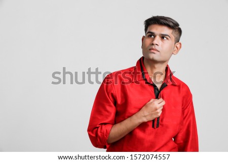 Indian / Asian man in red shirt and showing multiple expression over white background 