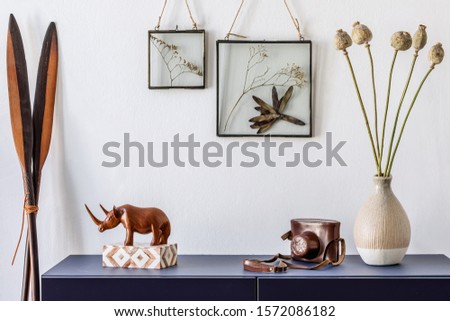 Modern scandinavian interior design with mock up photo frames, navy blue commode, flowers in vase and elegant accessories. Stylish home decor. Living room. Template Ready to use. 