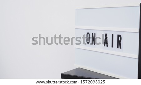 Light box sign with word "on air "put on table with white background.