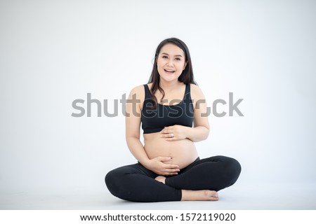Meditate when giving birth Close-up of pregnant women meditating while sitting in a lotus position.