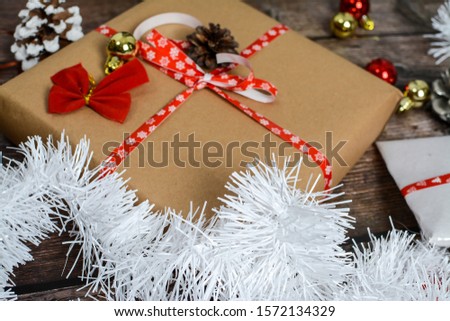Christmas gifts and various small decorations on wooden background