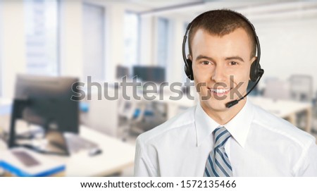 Confident call center operator agent in headset with microphone consulting