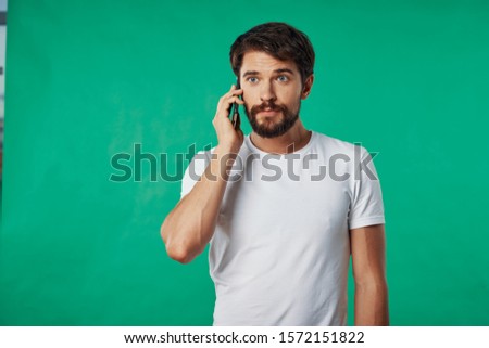 Cheerful man talking on the phone white shirt communication service