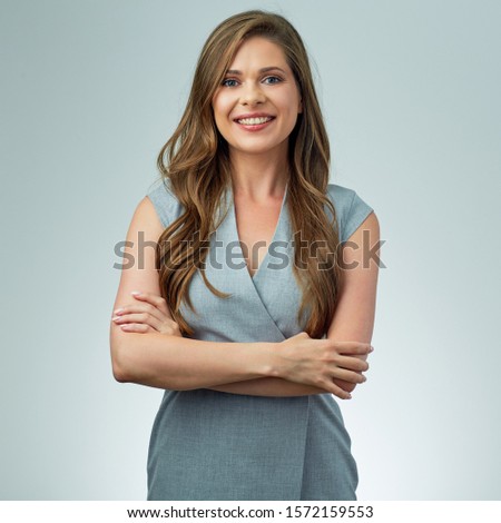 Smiling positive woman in gray business derss isolated studio portrait.