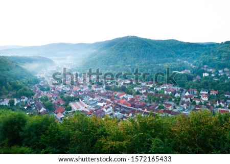 Aerial drone bird eye view photo of european village of central europe with red roofs and cozy streets in green valley beautiful natural morning sun lights