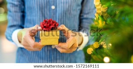 Woman hands holding gift box with Christmas tree. Christmas and New year, Valentine's, Graduate, Celebrate.