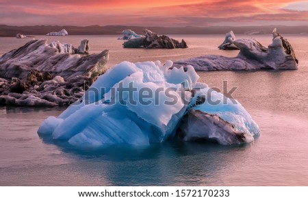 Incredible nature landscape of Iceland. Icebergs on Jokulsarlon glacier lagoon with Vatnajokull glacier in the background during sunset. Iceland. Iconic location for landscape photographers.