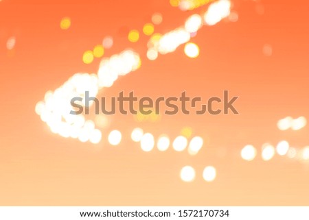 Abstract background blur bokeh bright colored circles on orange texture abstract image.