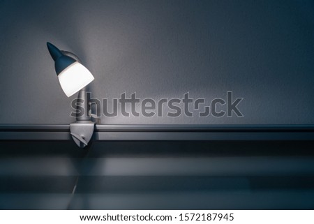 Spot light on a glass partition on the table