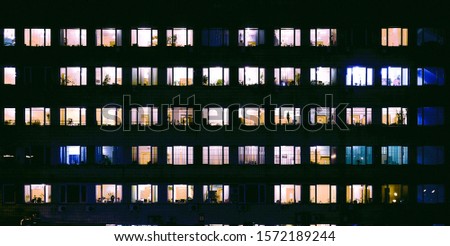 tetris of windows with light inside in the evening Royalty-Free Stock Photo #1572189244