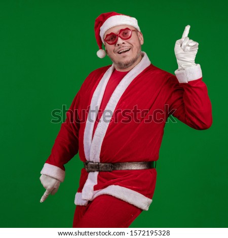 Santa Claus in pink glasses dances and gestures on a dark red background