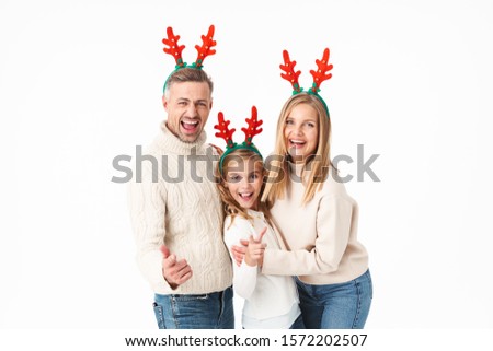 Image of caucasian family in Christmas reindeer antlers headbands pointing fingers at you isolated over white background