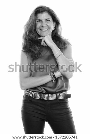 Studio shot of mature happy woman smiling and thinking