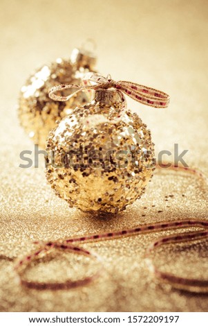 Golden christmas balls on glitter background with copy space.  Glitter background.