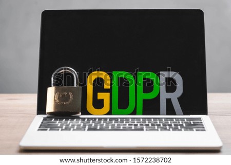 metal padlock and gdpr letters on laptop in office 