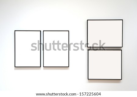 Four blank frames on a white wall