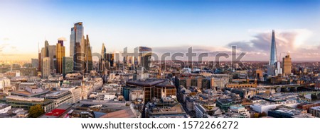 The new constructed skyline of London, United Kingdom, with the modern office buildings of the City until Tower Bridge and Thames river during sunset time