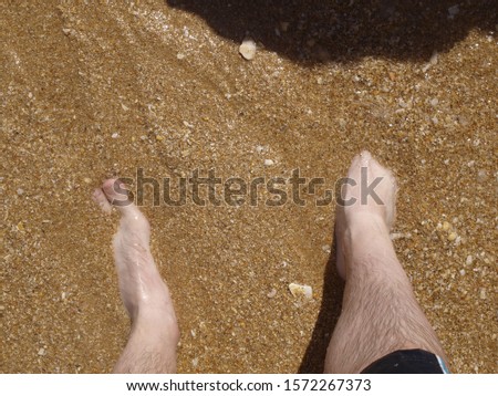Idyllic sunny beach holiday in Carvoeiro, Algarve, Portugal, rock pools, sandy beach in hot sunshine. Cliffs, splashing sea waves on the shore, travel under blue skies