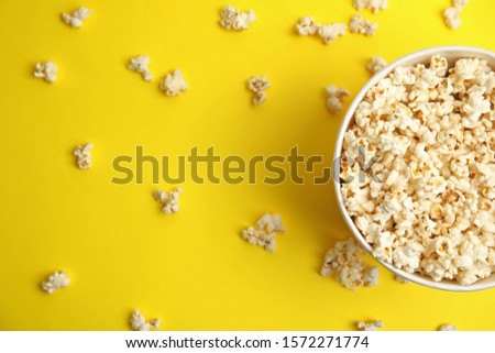 Tasty pop corn on yellow background, flat lay