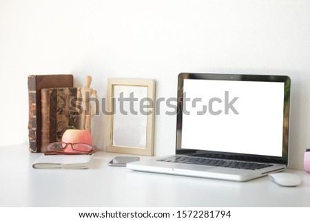 Work place concept Mockup blank screen  Office desk Workspace stuff with notepad, laptop and coffee cup mouse notepad shot.