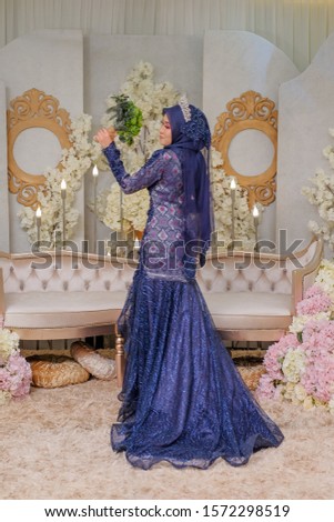 Indoor shooting for Malay wedding, the bride wearing Malay traditional  cloth in wedding ceremony . Happy & Family Concept