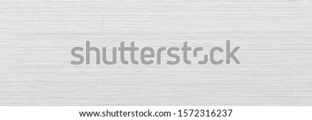 Brushed metal texture with uniform tone and horizontal grain.  Royalty-Free Stock Photo #1572316237