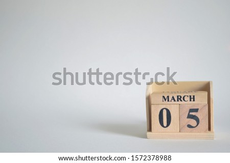 Empty white background with number cube on the table, March 5.
