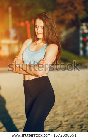 Girl in the park. The beauty is engaged in sports. Morning exercise on the nature.