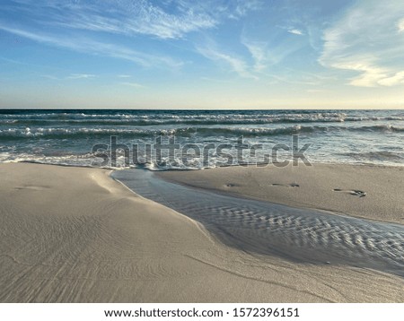 Seascape with textures in the sand and view of ocean water