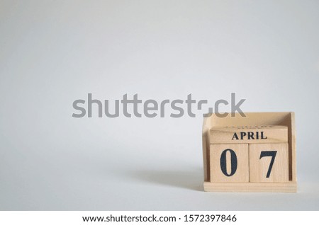 Empty white background with number cube on the table, April 7.