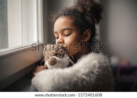 little girl kisses her plush toy
