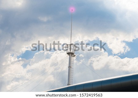 Light pole flashing signal on the building.