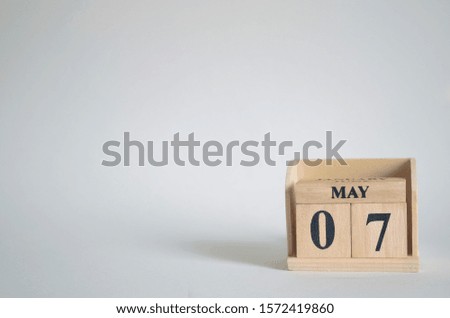 Empty white background with number cube on the table, May 7.