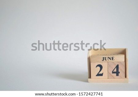 Empty white background with number cube on the table, June 24.