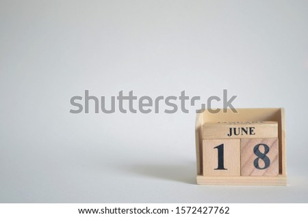 Empty white background with number cube on the table, June 18.