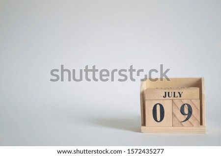 Empty white background with number cube on the table, July 9.