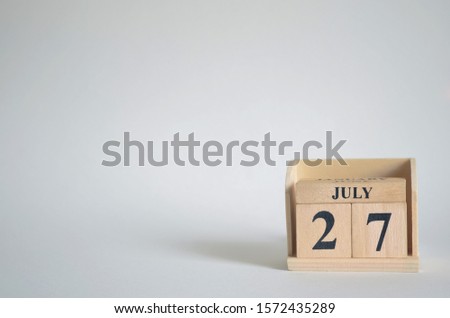 Empty white background with number cube on the table, July 27.