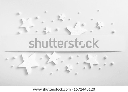Christmas minimal mockup - monochrome layout with stars and snow. Horizontal composition, flat lay, top view. White copy space. Winter season. Creative christmas mockup.